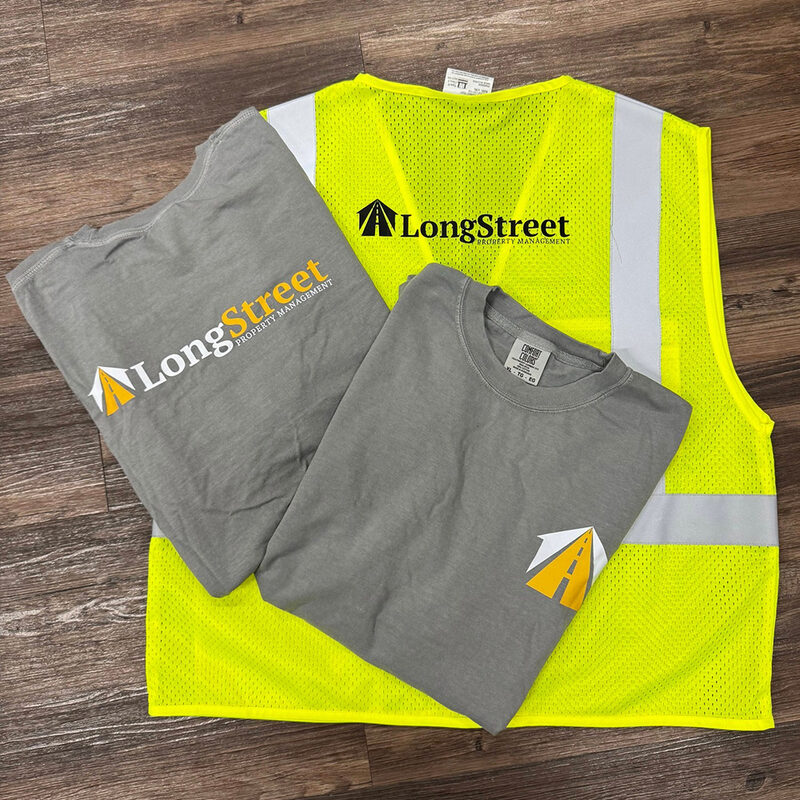 Branded grey tees and a hi-vis safety vest printed for a property management company