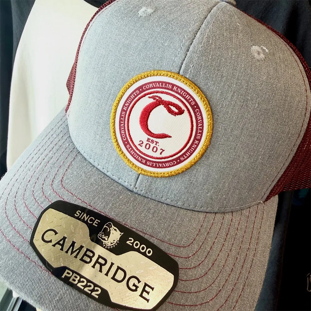 Full-colour digital patch applied to a grey and maroon trucker cap
