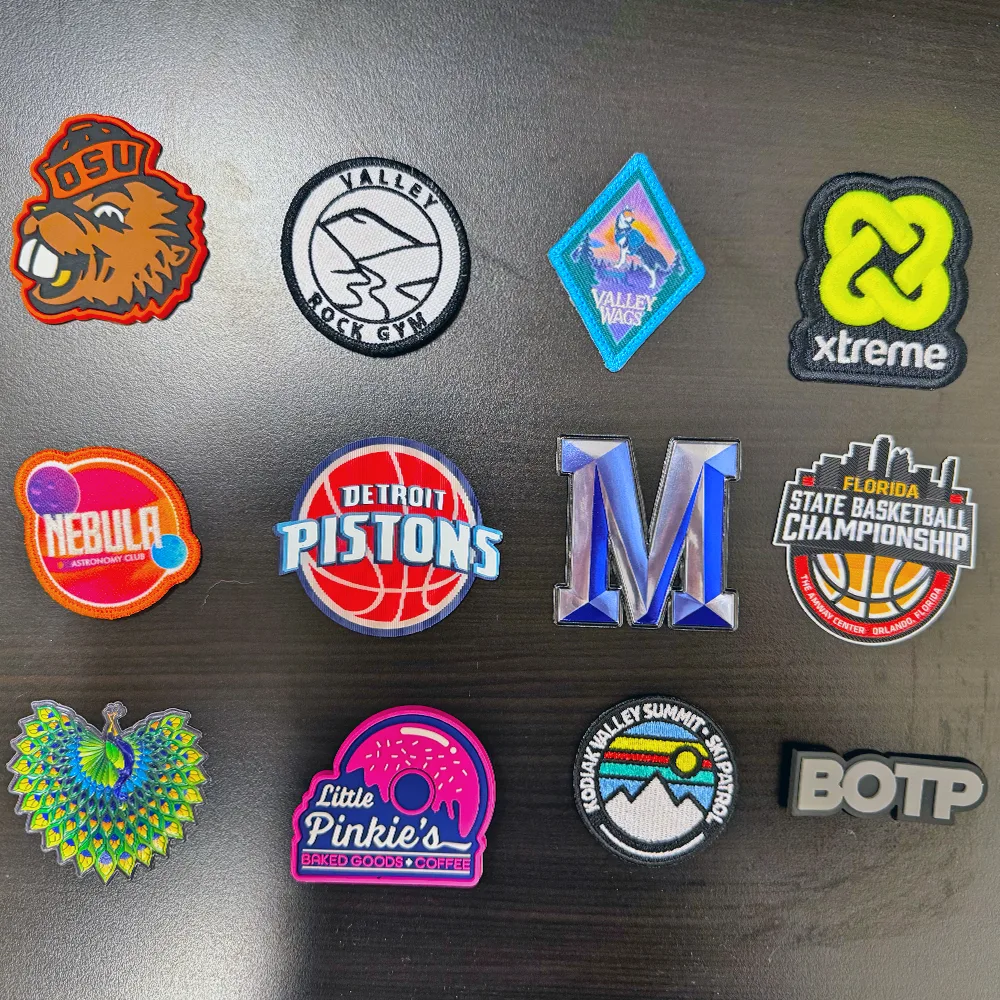 A dozen finished custom patches in PVC, leather, stitched and digital constructions