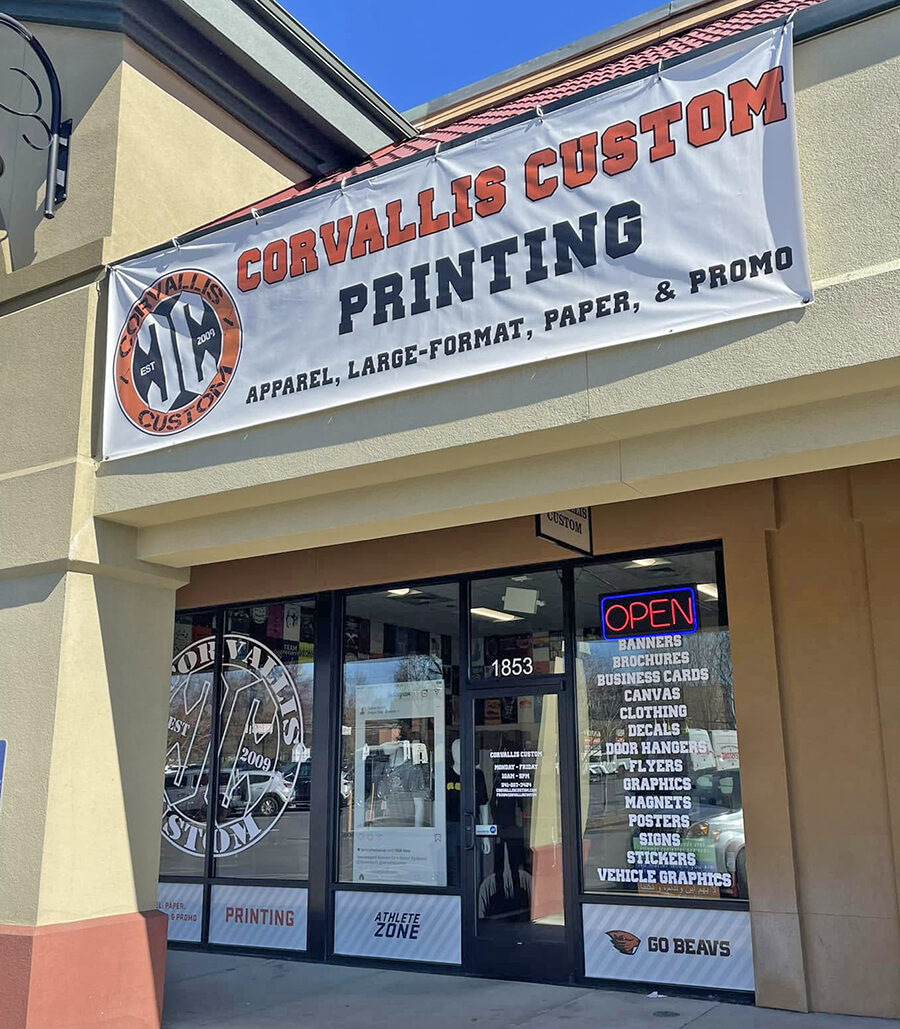 The Corvallis Custom storefront at 1853 NW 9th Street, with a printing banner above the entrance