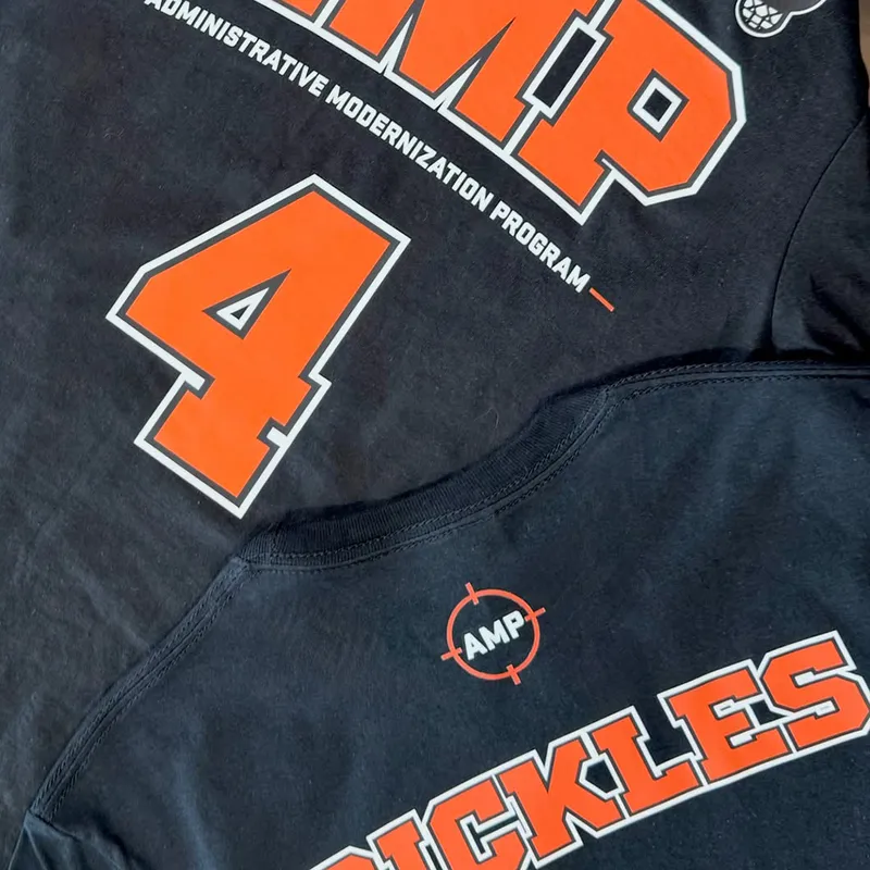 Custom numbered team jerseys printed in orange and white on black