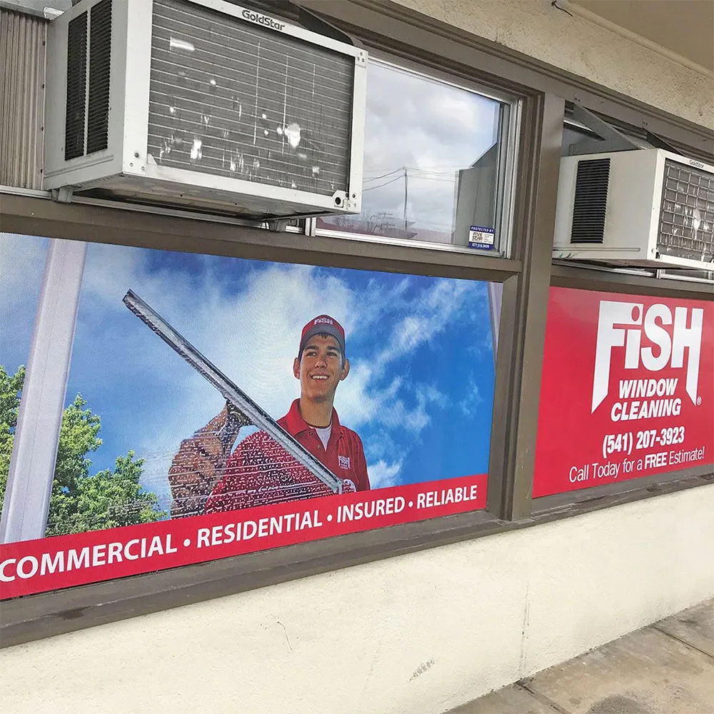 Full colour window graphic across a commercial storefront window, printed edge to edge with photography and contact details